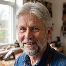 Portrait of an experienced woodworker in a bright workshop